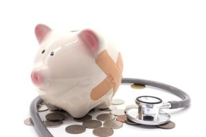 stethoscope with pink piggy bank and coins