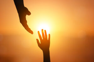 reaching hands in sun
