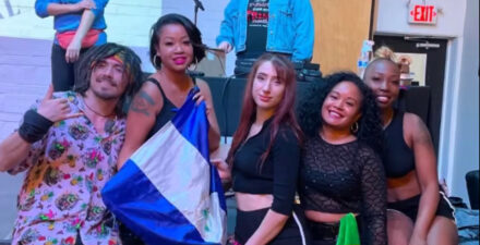Dancers pose on stage between performances at Caribbean Queens Fest.
