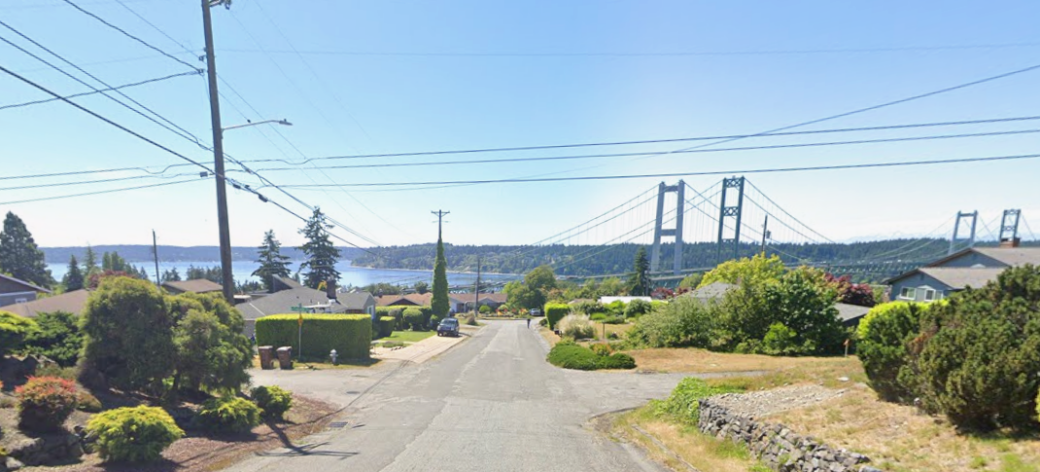 Street view taken on North 15th Street near Cascade Avenue facing west. Power lines are visible. Narrows Bridge is visible in the background.