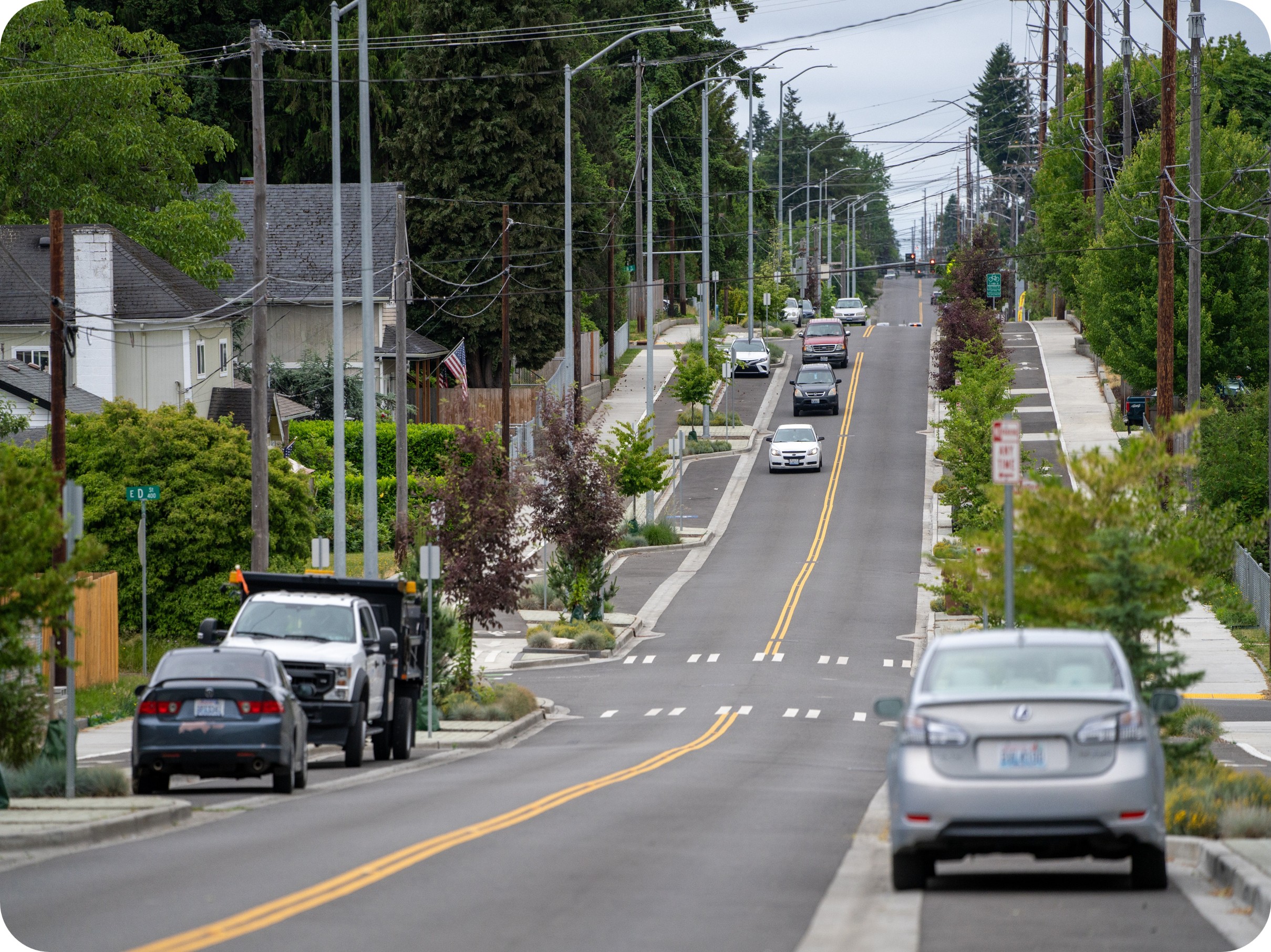 Street view of new planting strips, street parking, and pedestrian amenities along 64th Street
