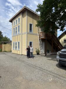 Homeowners standing in front of new detached accessory dwelling unit. 