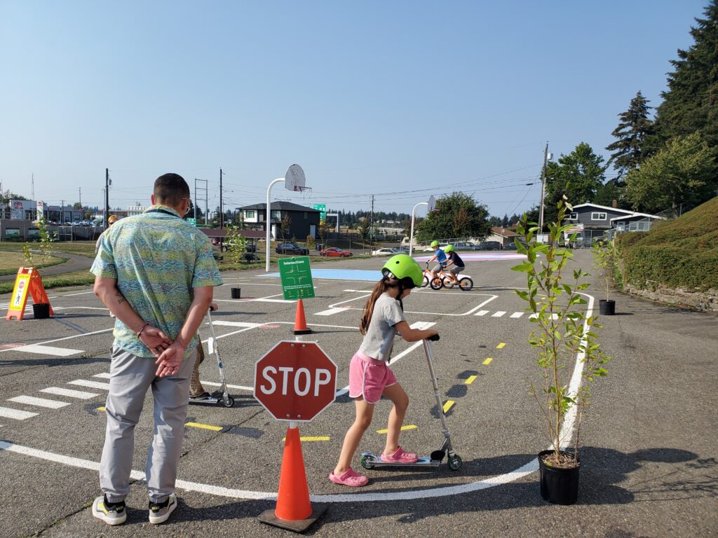 Children riding bikes and scooters at the permanent traffic garden at Jennie Reed Elementary School. 