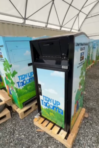 new public garbage can sitting on a pallet ready to be installed.