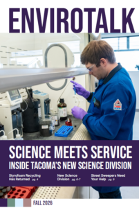 Cover of the Fall 2026 EnviroTalk showing an Environmental Services laboratory staff member wearing safety glasses and gloves while working with a water sample in a lab. Text reads, “Science Meets Service: Inside Tacoma’s New Science Division.”